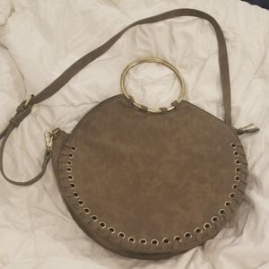 Suade whipstitched round bag with metal handle